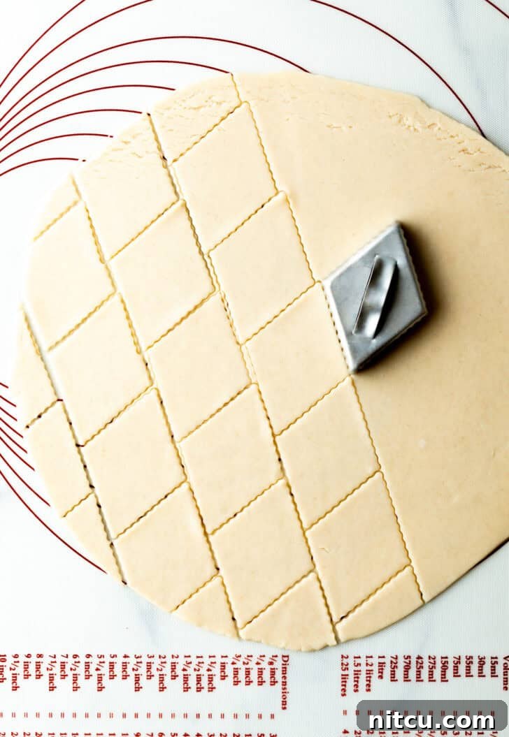 Sweet Cherry Pie Delight 8 A diamond stamper creates an elegant pattern on raw pie dough, showcasing a decorative technique for the pie's top crust.