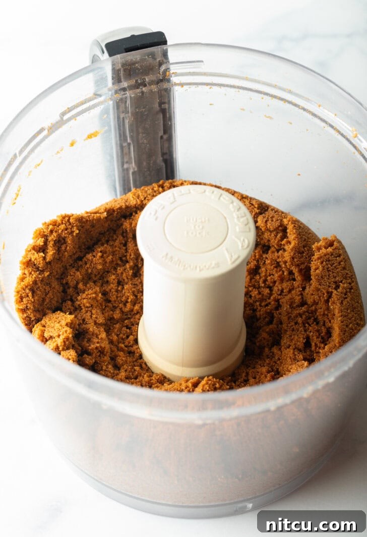Sheet Pan No-Bake Pumpkin Cheesecake 6 Pulverized gingersnap cookies in a food processor.