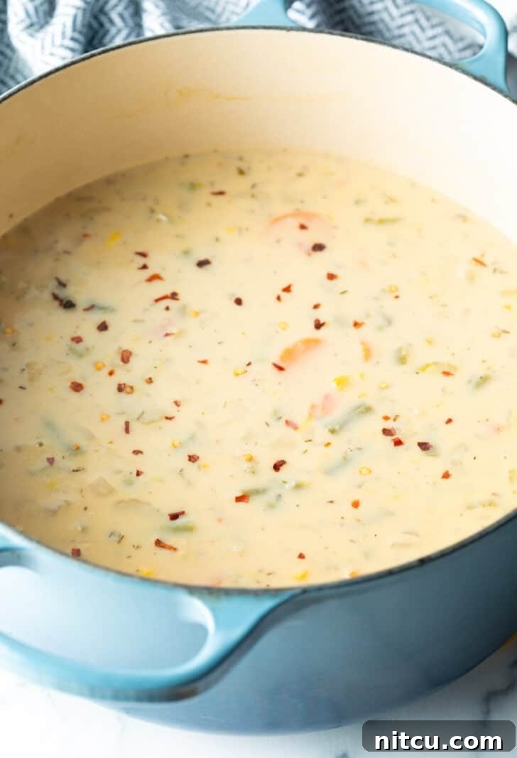 Velvety Garden Soup 8 Large blue pot of creamy soup with veggies.
