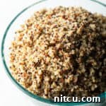 Glass bowl of fluffy quinoa.