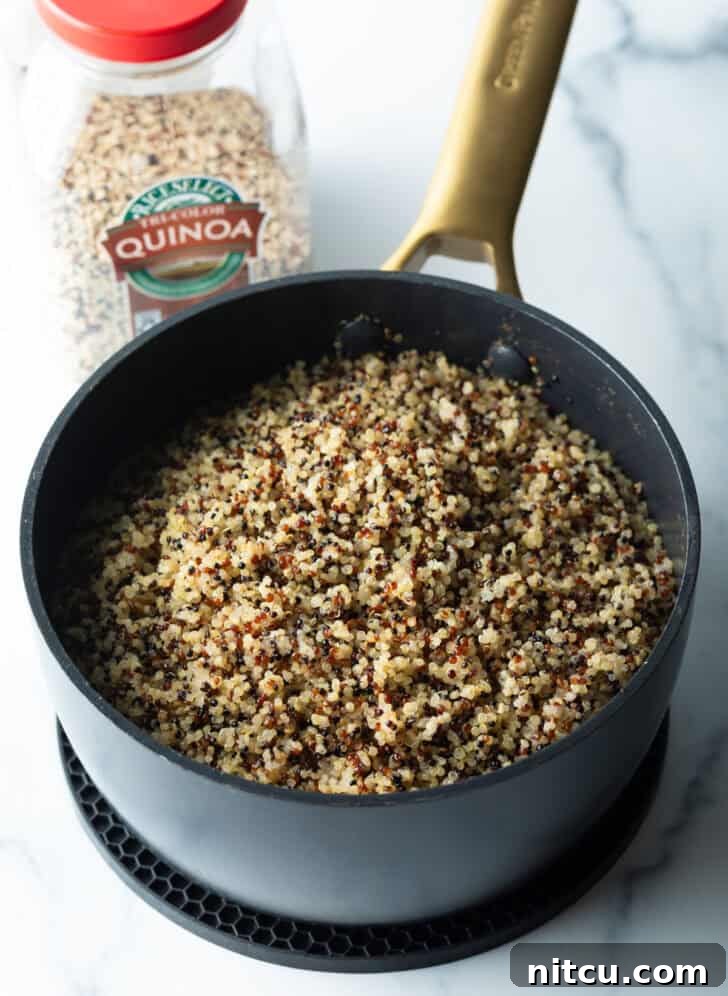 Perfectly Fluffy Quinoa 7 Cooked grains in a large black pot.