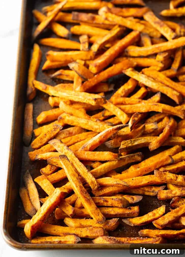 Crispy Air Fryer Sweet Potato Fries 8 Baking sheet covered with baked sweet potato fries.