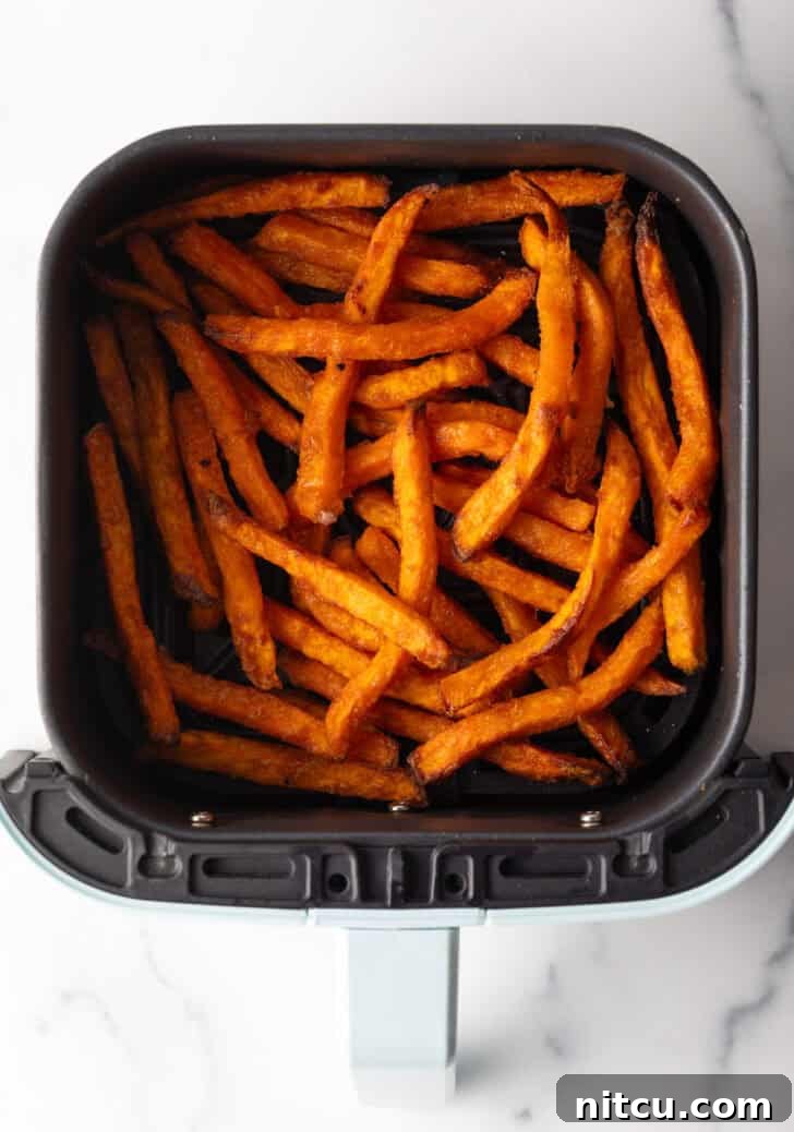 Crispy Air Fryer Sweet Potato Fries 9 Sweet potato fries in an air fryer.