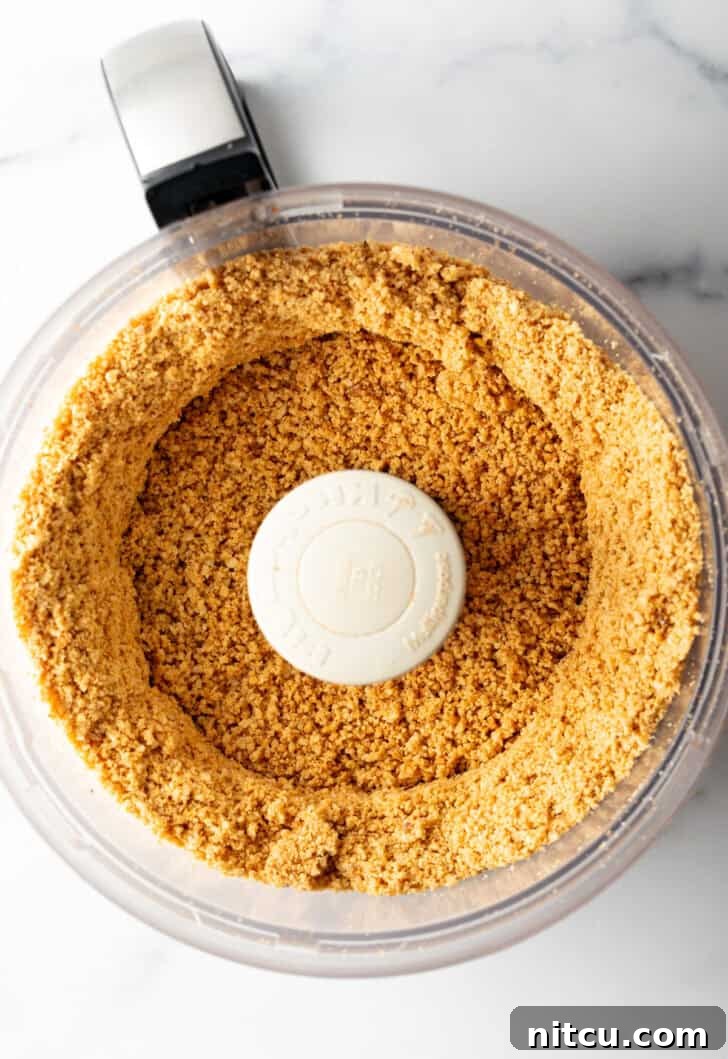 Whip Up Your Own Peanut Butter 6 Close-up of peanuts starting to blend into crumbs in a food processor.