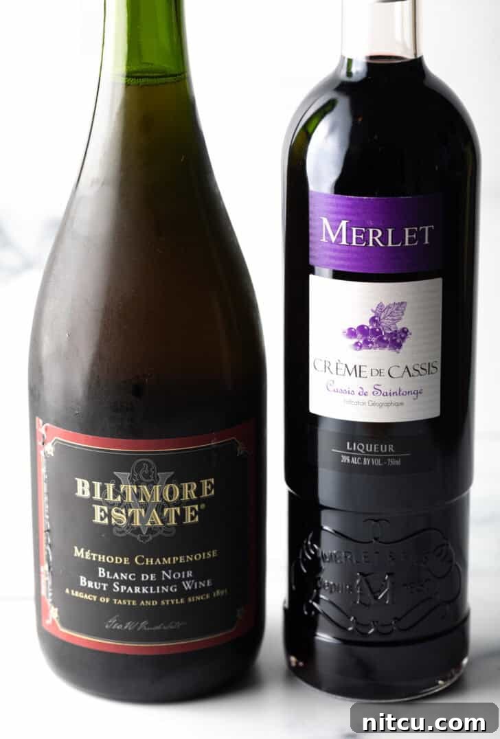 Regal Berry Fizz 5 A pristine bottle of champagne stands alongside a bottle of rich crème de cassis.