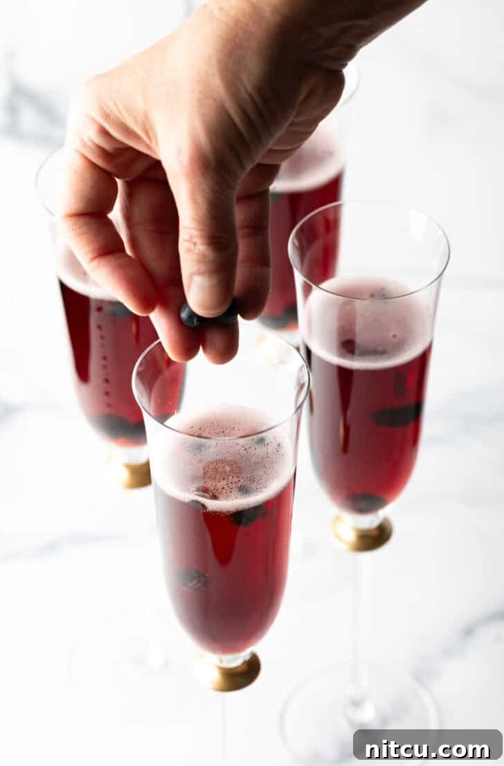 Regal Berry Fizz 8 A perfectly prepared Kir Royale cocktail shimmering in a champagne flute.