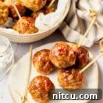 Tangy Apple Butter Glazed Meatballs 3 Gluten Free Meatballs with Apple Glaze on plate