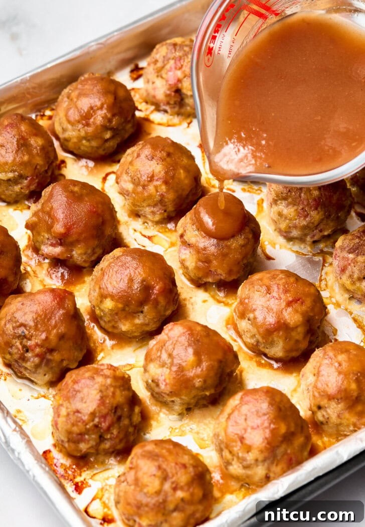 Spiced Apple Cocktail Meatballs Recipe | ASpicyPerspective.com Pour glaze over meatballs