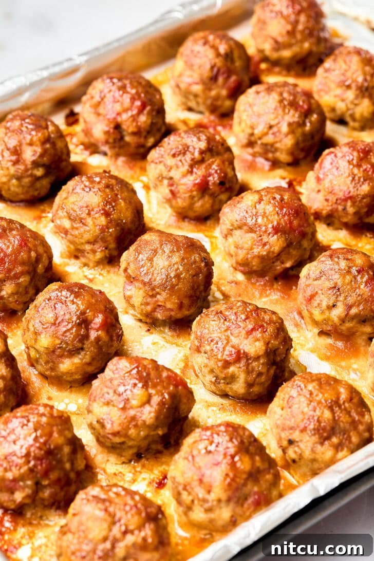 Spiced Apple Cocktail Meatballs | ASpicyPerspective.com #recipe #holidays #party Gluten Free Meatballs - baked meatballs on tray