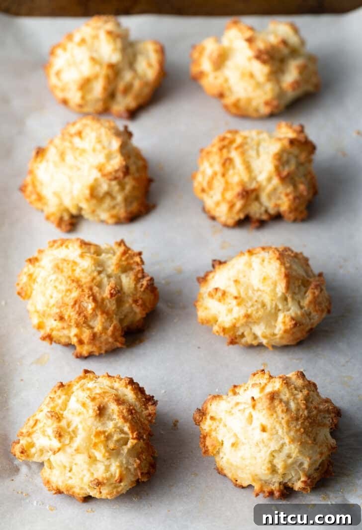 Pillowy Buttermilk Drop Biscuits 10 Two rows of 8 baked drop biscuits on a baking sheet.