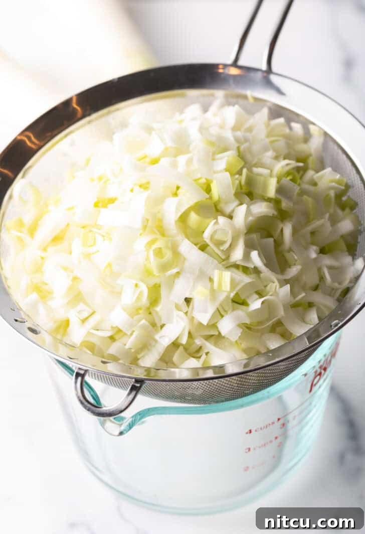 Draining a colander of shaved leeks.