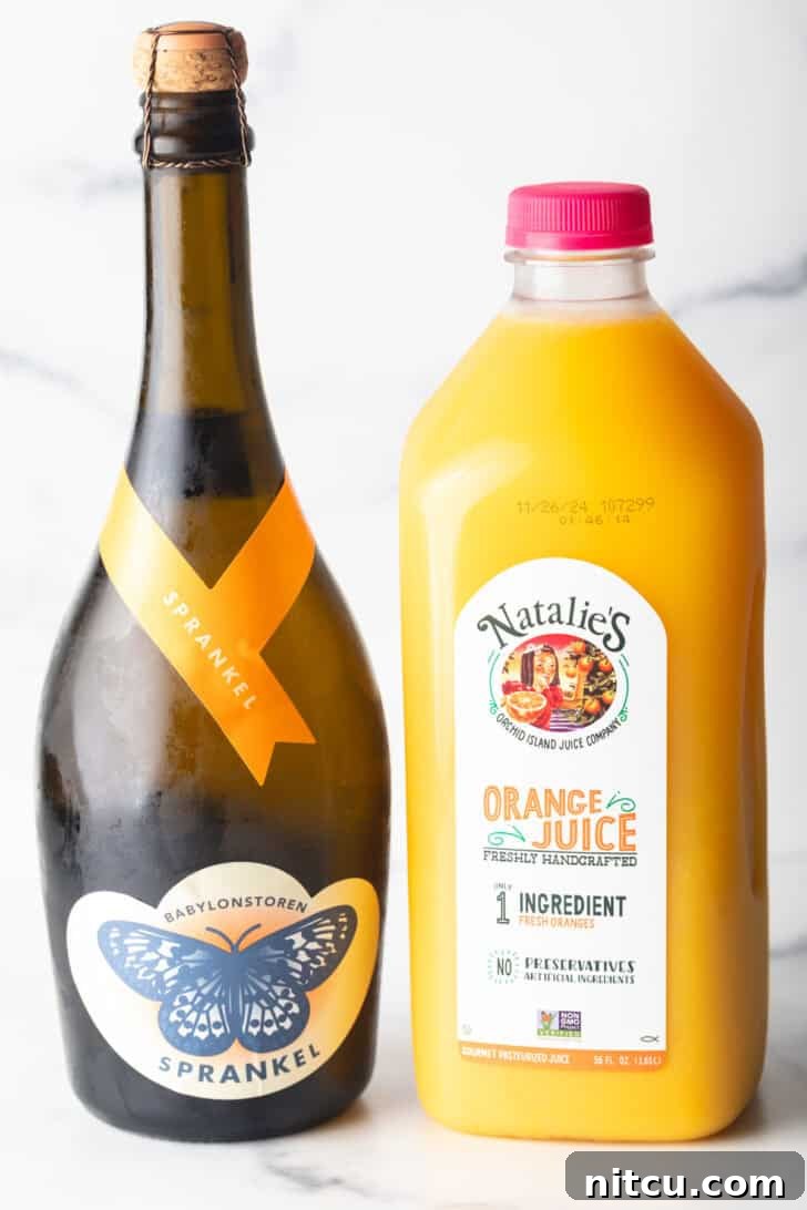 The Ultimate Mimosa Recipe 5 A bottle of champagne next to a bottle of orange juice.