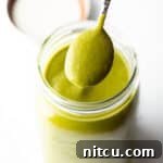 Spoonful of poblano sauce showing to camera.