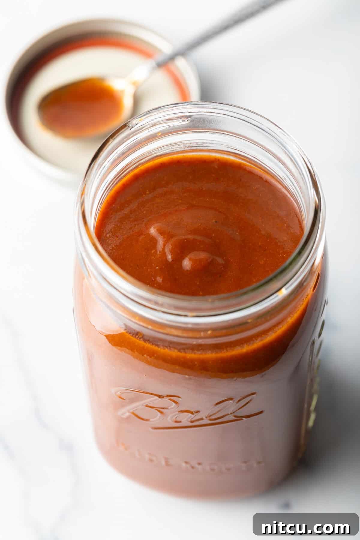 Authentic Red Enchilada Sauce 10 Top down view of red sauce in a large glass jar.