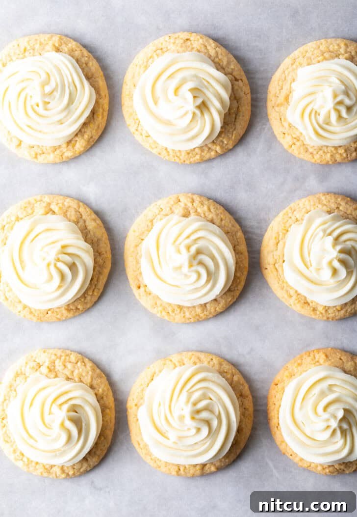 Honey Butter Cornbread Delights 4 Top down view 9 frosted honey butter cookies on a baking sheet.