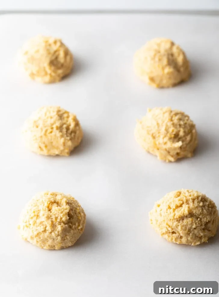 Honey Butter Cornbread Delights 6 6 balls of cookie dough on a baking sheet.