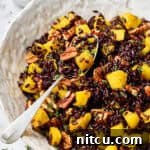 Black Rice Recipe in white bowl with spoon and butternut squash