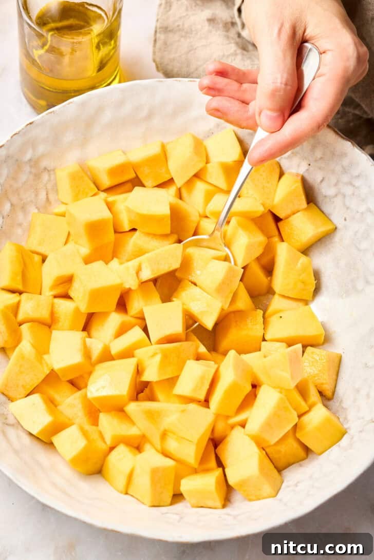 Royal Purple Rice Dish 3 Chopped butternut squash in a bowl, drizzled with oil, ready for roasting.
