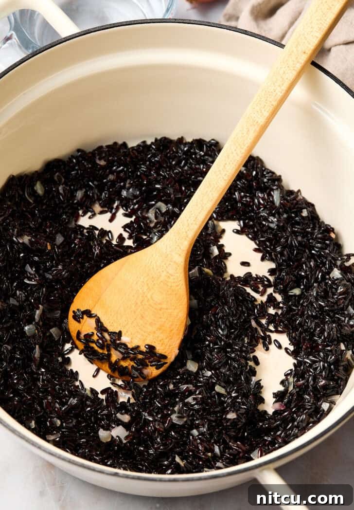 Royal Purple Rice Dish 4 Black rice cooking in a pot on the stovetop, covered.