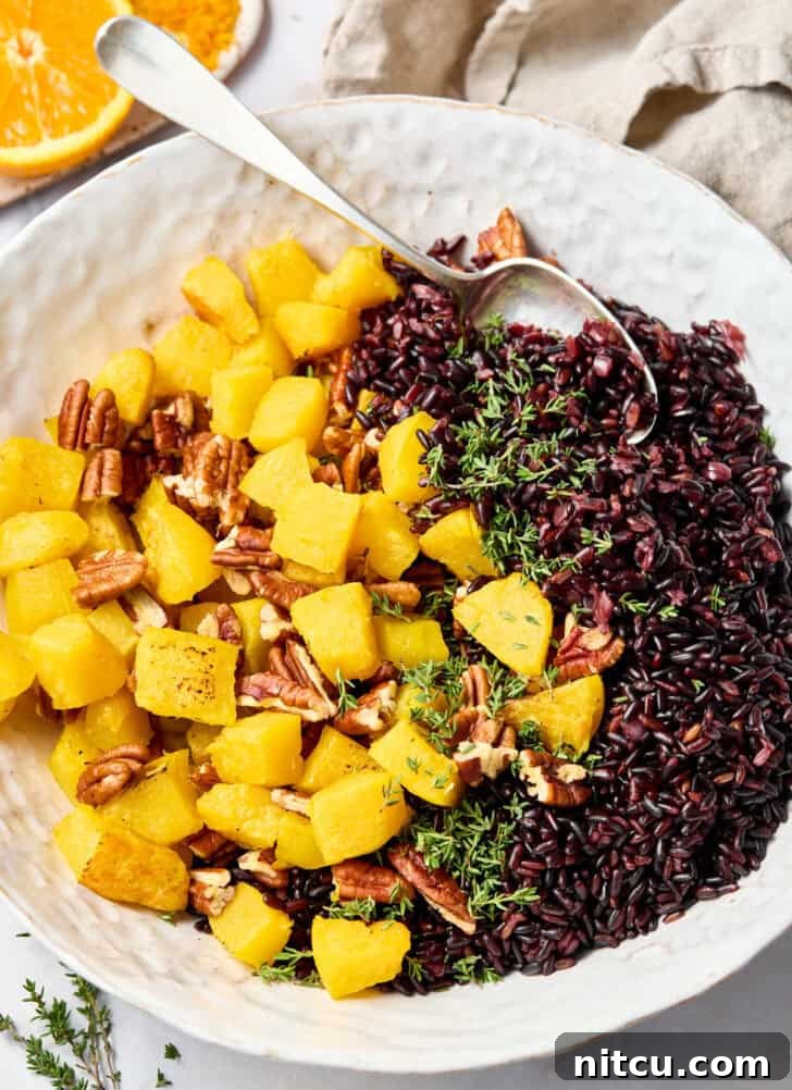 Royal Purple Rice Dish 5 Mixing roasted acorn squash and pecans with cooked forbidden rice in a bowl.