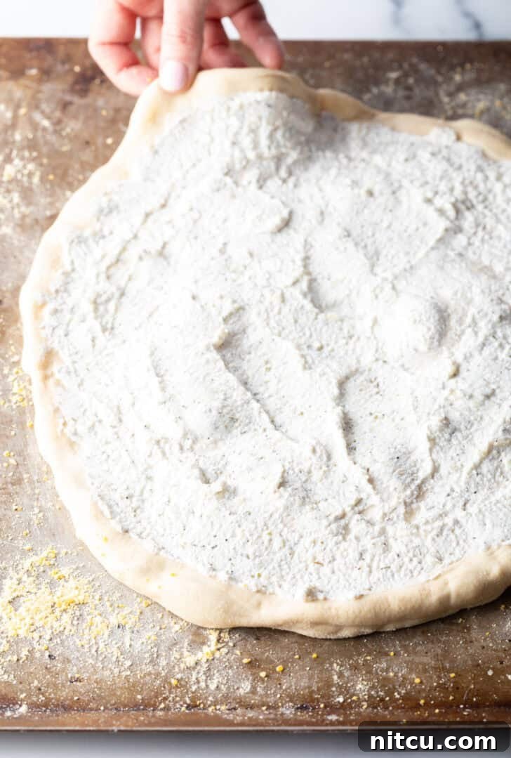 Homemade White Pizza Perfection 7 Unbaked pizza crust topped with creamy white sauce.