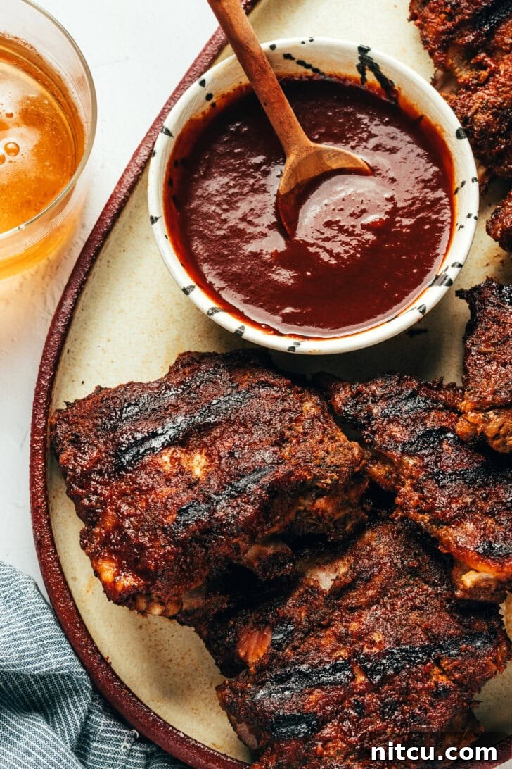 Fall-Off-The-Bone Oven Ribs 4 Close-up of baby back ribs with coffee BBQ sauce on a platter, ready to serve