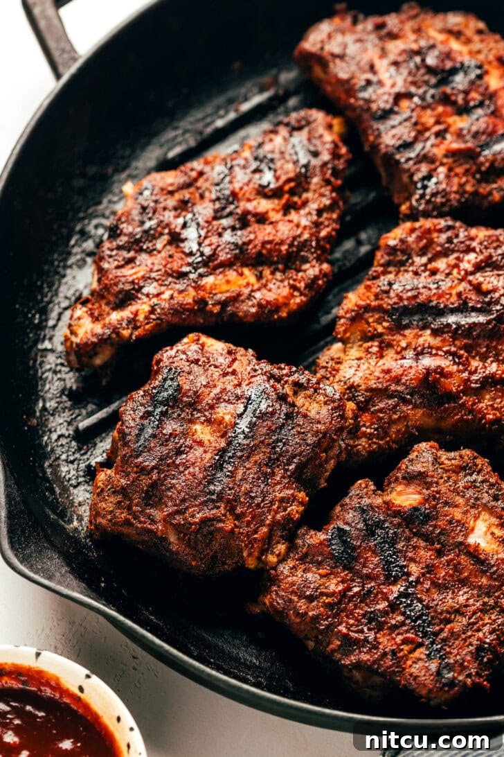 Fall-Off-The-Bone Oven Ribs 10 Grilled baby back ribs piled high, glistening with barbecue sauce
