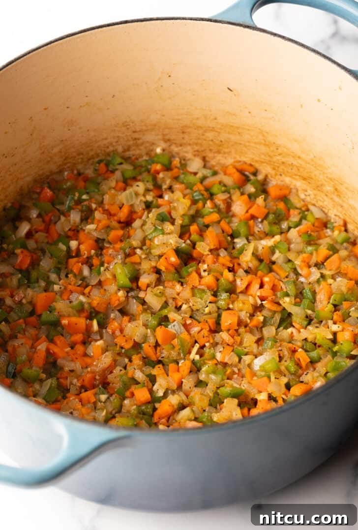 Slow-Simmered Sunday Meat Sauce 6 Large pot with chopped sauteed veggies.