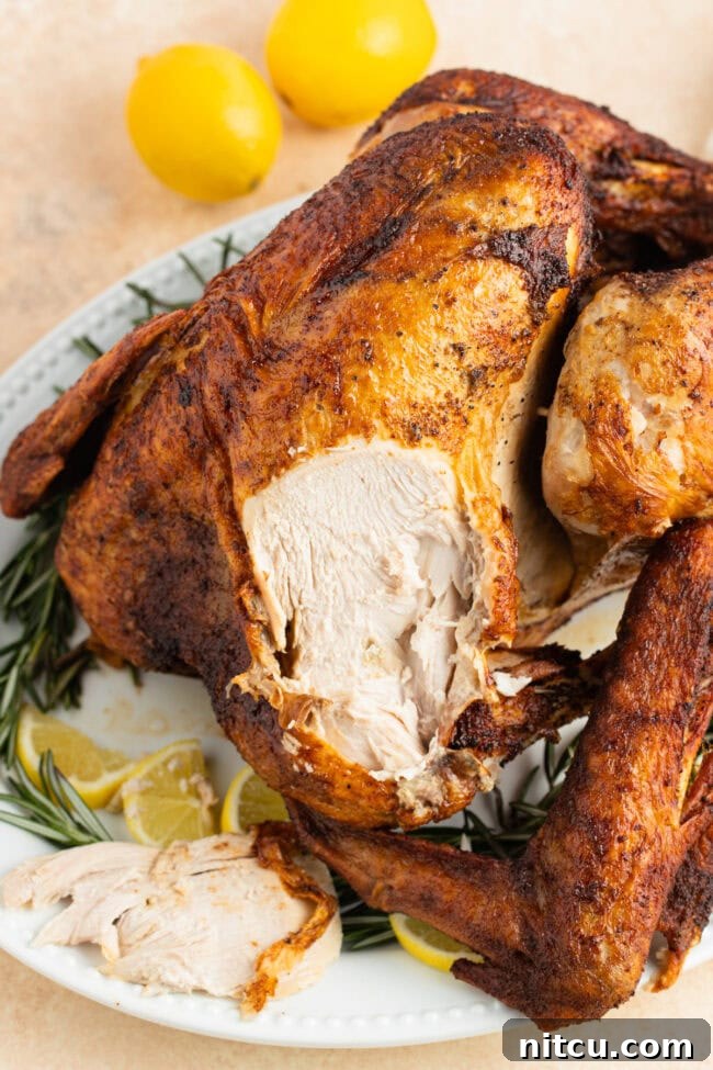 turkey Turkey on a serving platter with a piece sliced off of the breast.
