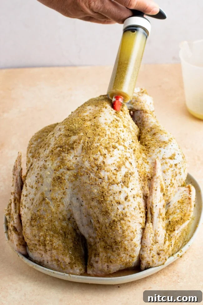 seasoning Injecting a raw turkey with a marinade.