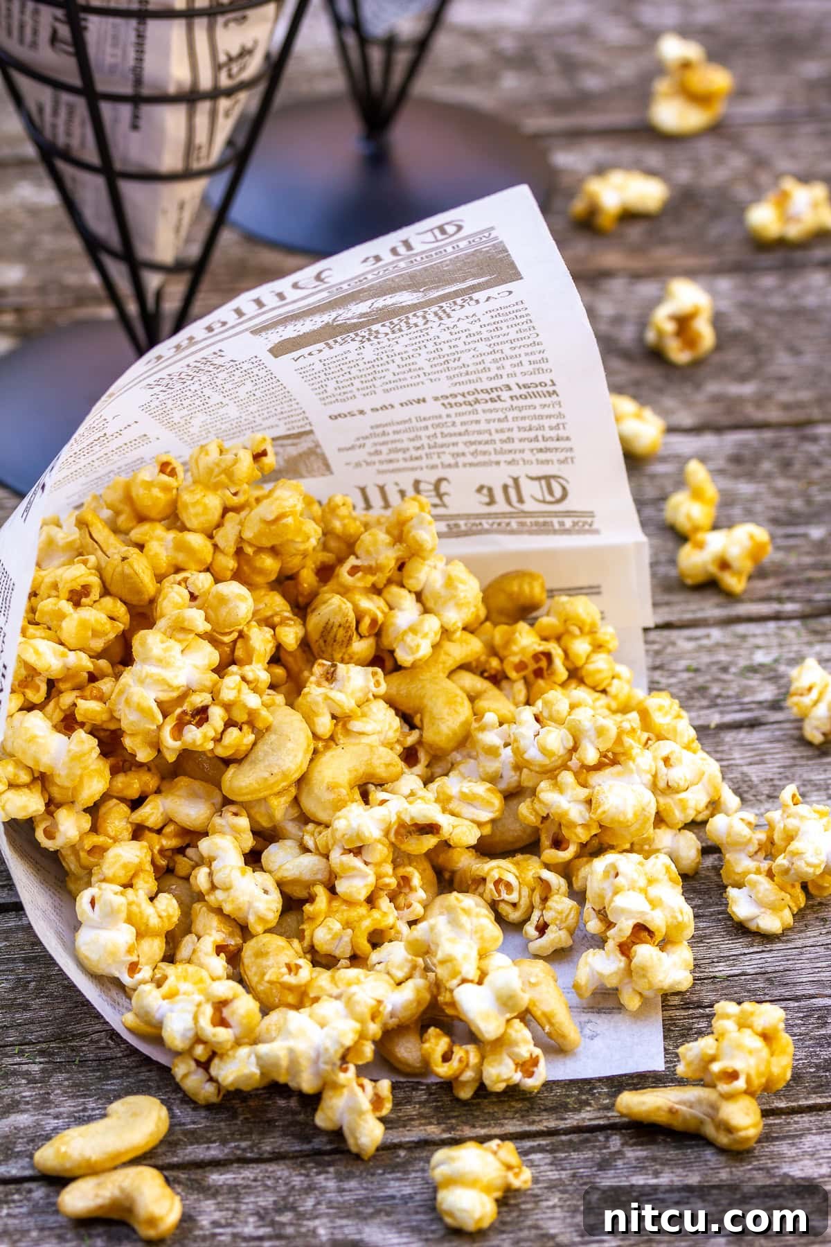 Perfect Caramel Popcorn A charming close-up shot of homemade caramel popcorn in a paper cone, highlighting its delicious texture and perfect caramel coating.