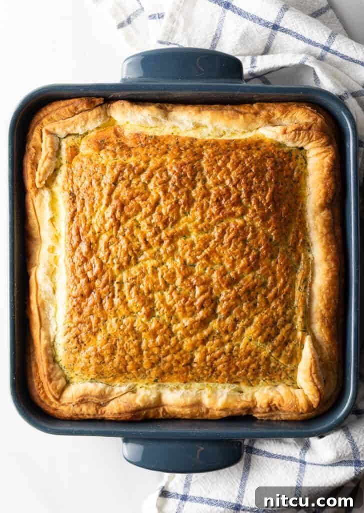 The Ultimate Effortless Breakfast Bake 11 A top-down view of the square baking dish filled with the easy egg bake breakfast casserole, golden and ready to be served.