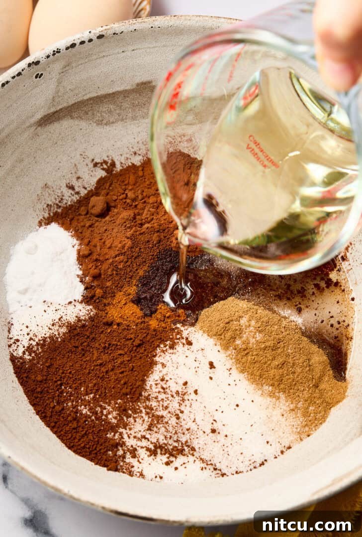 Fudgy Mexican Mocha Crinkle Cookies | ASpicyPerspective.com #christmas #cookies #recipe Mexican Crinkle Cookies - Dry ingredients in a mixing bowl, ready to be combined.