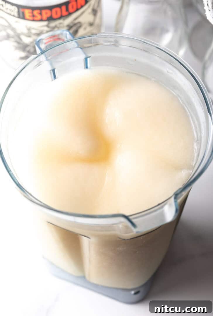 The Ultimate Frozen Margarita 9 Blending margarita ingredients.