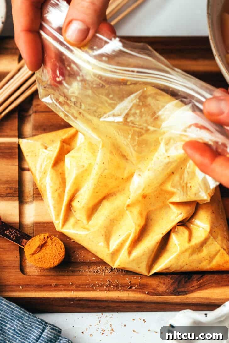 Sizzling Chicken Satay Skewers 6 A large Ziploc bag meticulously filled with chicken pieces thoroughly coated in a rich satay marinade.