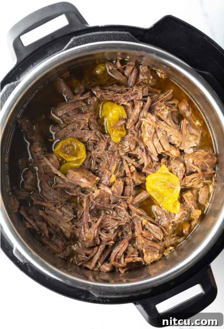 Melt-in-Your-Mouth Mississippi Pot Roast 6 Top down shredded beef in an instant pot.
