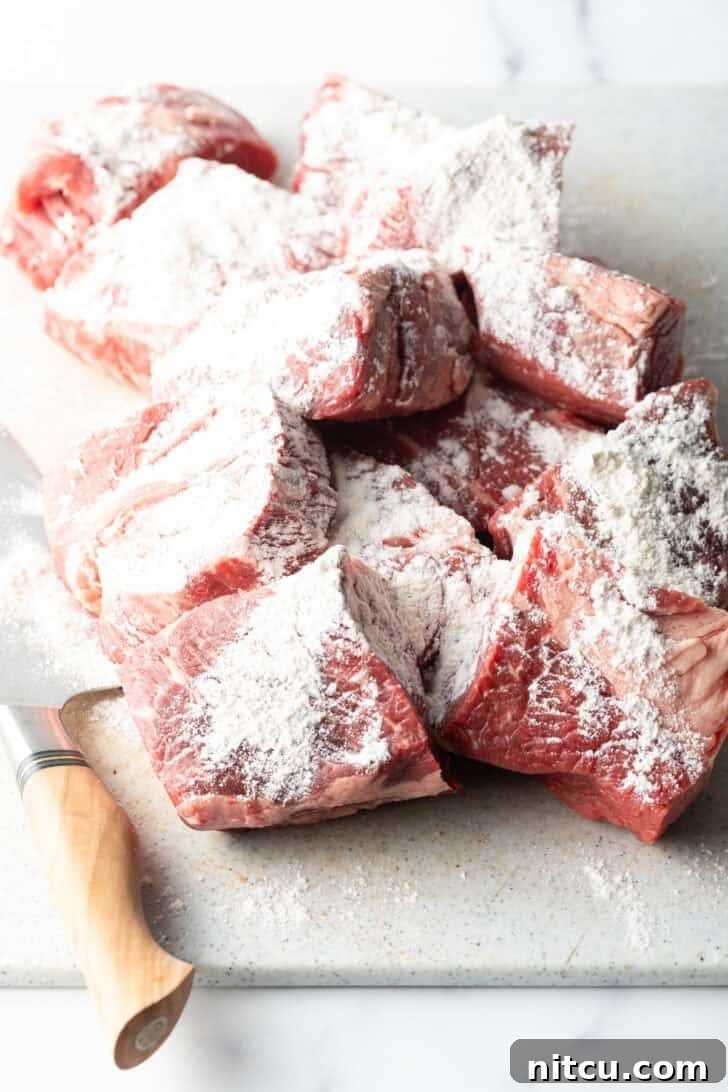 Melt-in-Your-Mouth Mississippi Pot Roast 8 Large chunks of raw beef coated in flour.