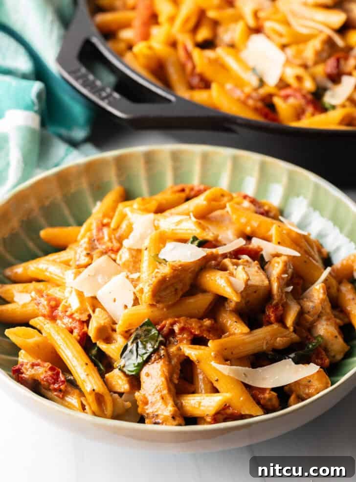 Proposal-Worthy Chicken Pasta 12 A vibrant green bowl filled with spicy Marry Me Chicken Pasta, ready to be enjoyed.