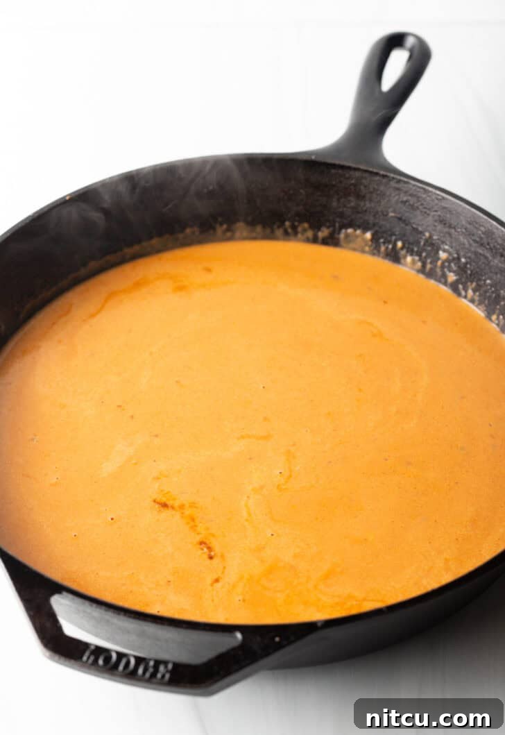 Proposal-Worthy Chicken Pasta 8 A rich, creamy tomato sauce simmering in a cast iron skillet.