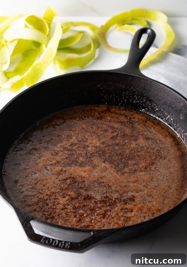 Caramelized Apple Bliss 8 Caramelized sugar, butter, and spices melting together in a cast iron skillet, forming the glaze base.