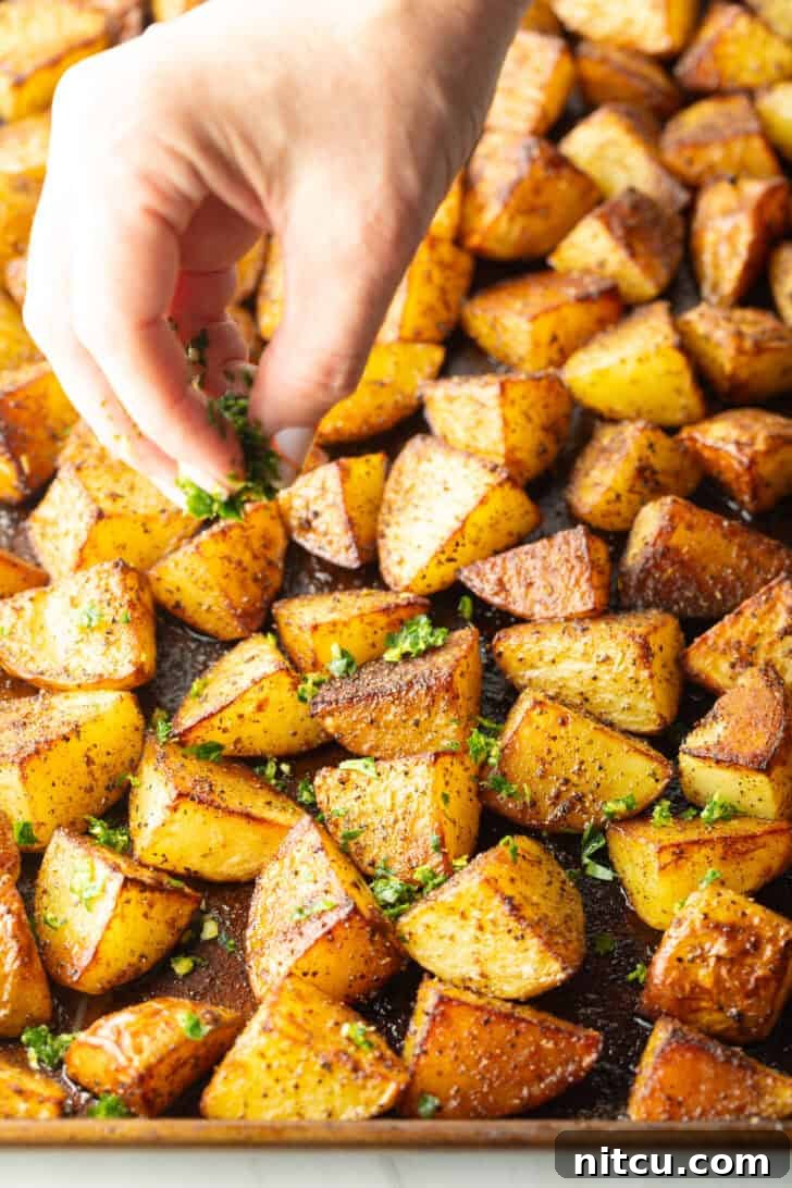 Crispy Potato Gold 8 Roasted golden potatoes on a baking sheet.