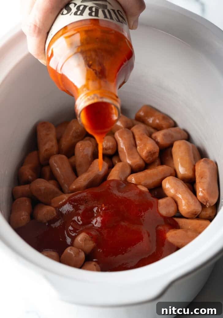 Glazed Cocktail Smokies 7 Pouring BBQ sauce over lil smokies in a white crock pot.