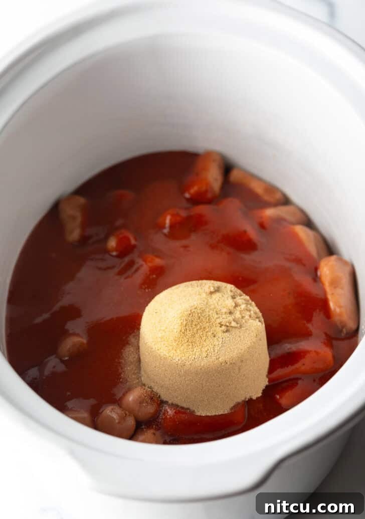 Glazed Cocktail Smokies 8 A scoop of brown sugar added to the slow cooker with smokies and barbecue sauce.