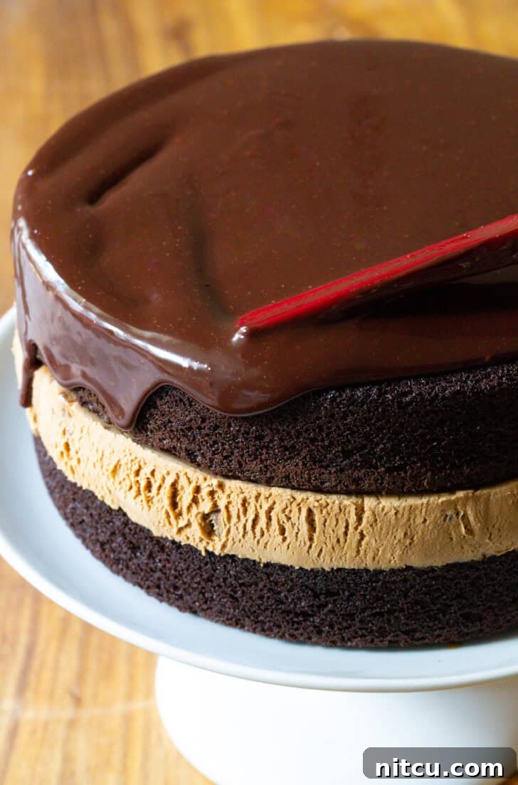 Ultimate Ice Cream Cake 11 Covering chocolate and caramel ice cream cake with dripping chocolate ganache.