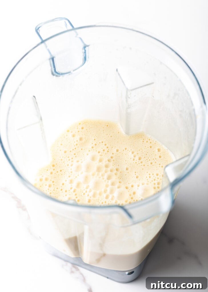 Effortless Puffed Pancake Perfection 5 Blender filled with smooth, light Dutch Baby batter, ready to be poured.