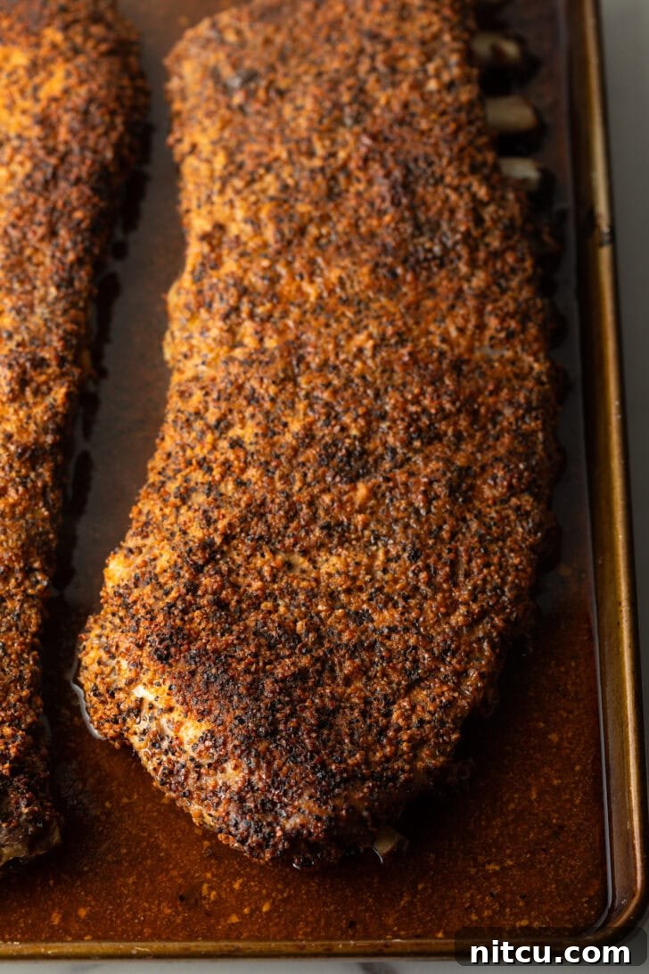 Gateway City Ribs 9 Cooked St. Louis ribs in an oven tray after the initial baking phase.