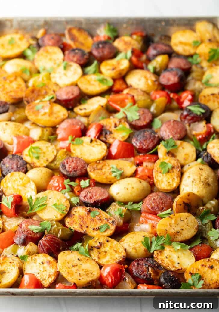 Smoky Sausage and Roasted Potatoes 8 Side view of a serving of sheet pan sausage and veggies, highlighting the roasted textures.