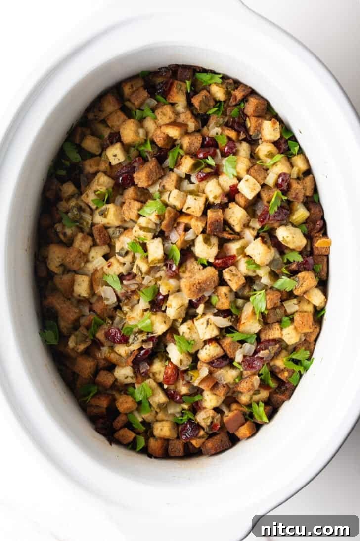 Effortless Crock Pot Stuffing 4 Overhead view of crock pot dressing in a white crock pot.