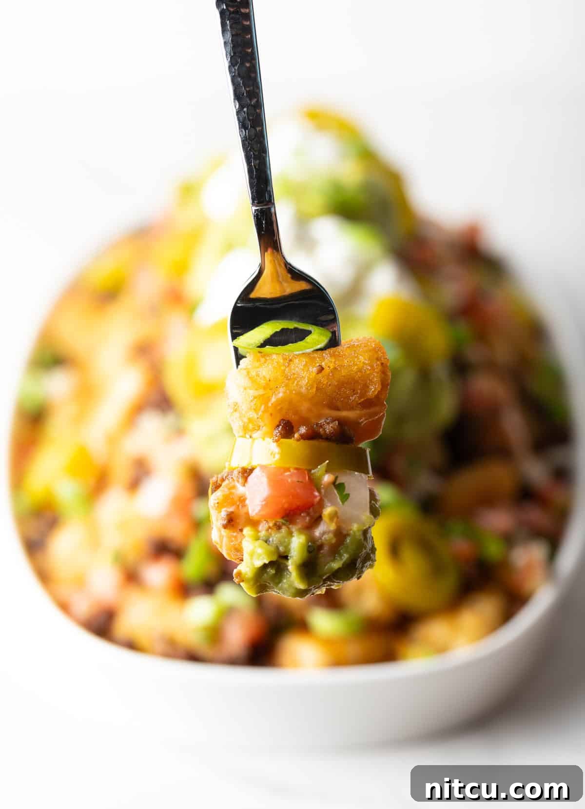 Ultimate Loaded Tots 5 Forkful of totchos held to camera.