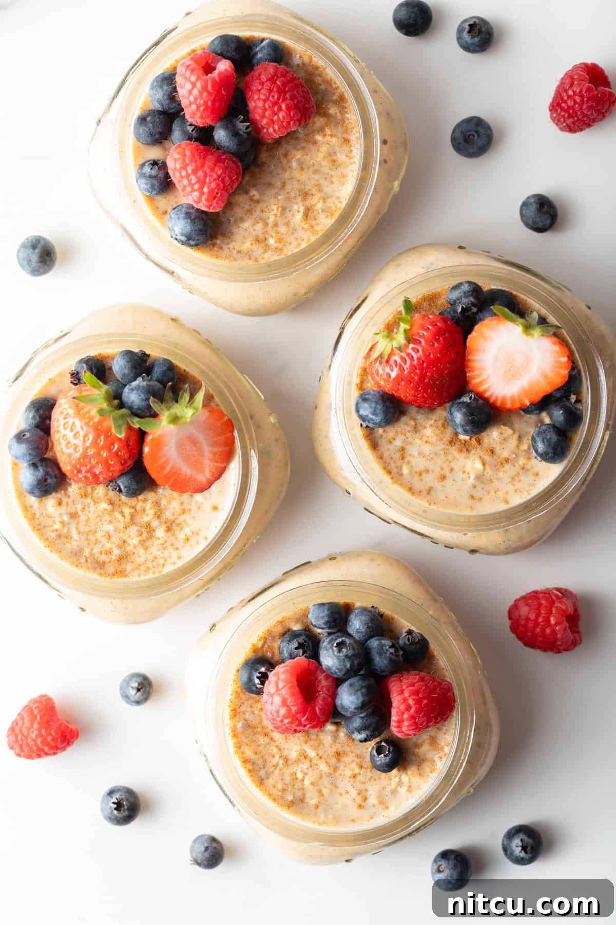 Protein Packed Next-Day Oats 2 Overhead shot of high protein overnight oats with protein powder and fresh berries